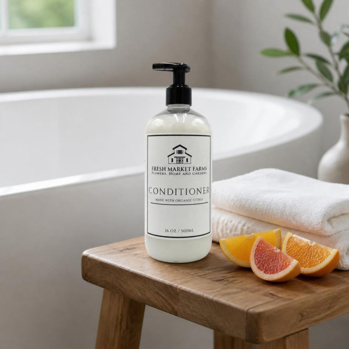 Citrus Conditioner on a stool beside a bathtub with citrus slices