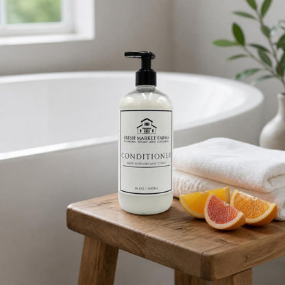 Citrus Conditioner on a stool beside a bathtub with citrus slices
