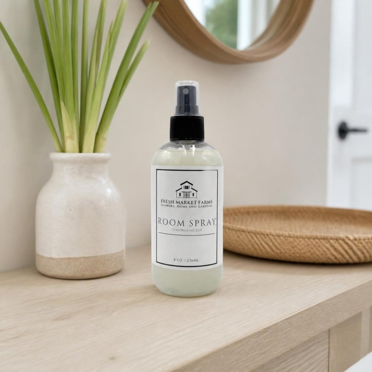 Lemongrass Room Spray on an entryway console with fresh lemongrass